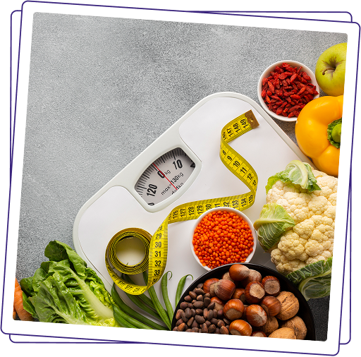 A weighing scale surrounded by fresh vegetables, fruit, lentils and nuts